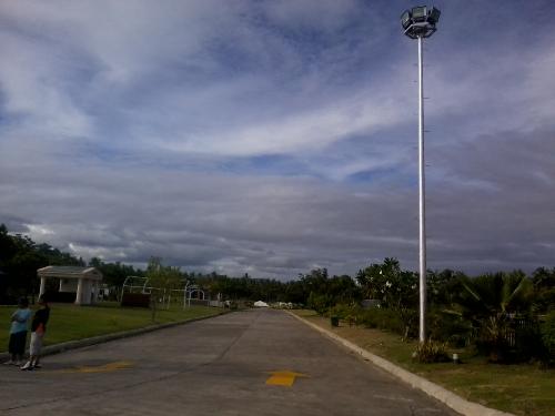 whirling sky - I capture this photo using my mobile phone, I was just amazed about the picture because I did not realize it looks as good as this. The whirling clouds I didn't really noticed that. What I was trying to capture was the road.The phone used was a SAMSUNG S3653.