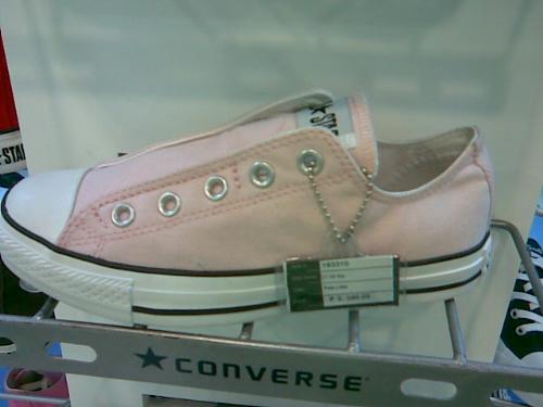 light pink Converse shoe - A photo of a light pink Converse shoe, without a lace. This is on sale inside a local shopping mall.