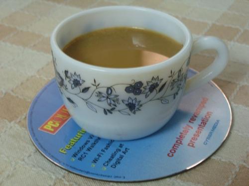 a tea cup  - here a waste CD is used as a cup support on a table