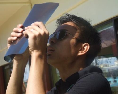 research, observe - This was taken in July 22, 2009 when I, together with my colleagues at Saint Mary's Publishing Corporation, observed solar eclipse. That eclipse was the longest solar eclipse of the 21st century.   SO this is me, wearing a Kaleido shades and holding upright an x-ray film to see the eclipse.