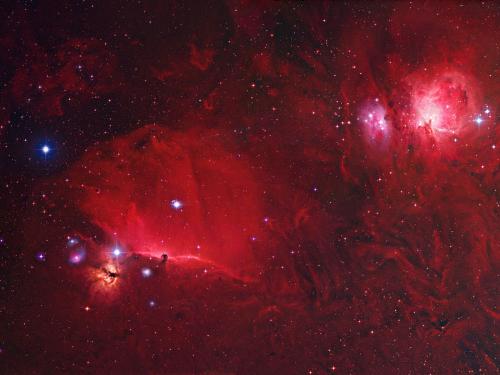 An Orion Deep Field  - Adrift 1,500 light-years away in one of the night sky's most recognizable constellations, the glowing Orion Nebula and the dark Horsehead Nebula are contrasting cosmic vistas. They both appear in this stunning composite digital image assembled from over 20 hours of data that includes exposures filtered to record emission from hydrogen atoms. The view reveals extensive nebulosities associated with the giant Orion Molecular Cloud complex, itself hundreds of light-years across. The magnificent emission region, the Orion Nebula (aka M42), lies at the upper right of the picture. Immediately to its left are a cluster of of prominent bluish reflection nebulae sometimes called the Running Man. The Horsehead nebula appears as a dark cloud, a small silhouette notched against the long red glow at the lower left. Alnitak is the easternmost star in Orion's belt and is seen as the brightest star to the left of the Horsehead. Below Alnitak is the Flame Nebula, with clouds of bright emission and dramatic dark dust lanes. Fainter tendrils of glowing hydrogen gas are easily traced throughout the region in this Orion deep field.