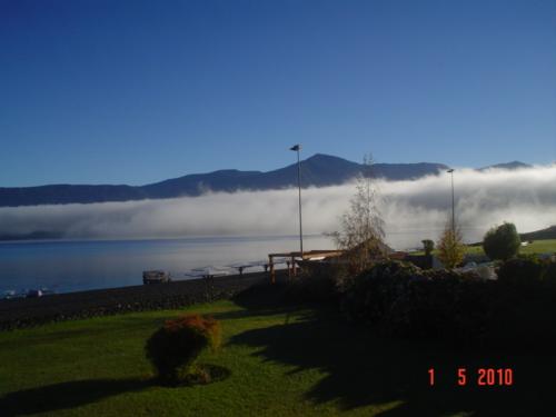 Pucón, Chile. Mist rising from the lake. - I took this picture from my terrace in the morning. The zone id filled with lakes and lake Villarrica is one of the most beautiful ones. The lake is surrounded by native forests and there are hotsprings 15 minutes away.