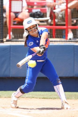 Women softball  - Women softball player hits ball at softball world series game