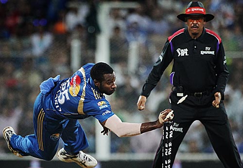 Pollard  - Pollard flying to hit the stumps with the ball.