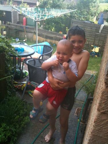 My Boys - Jason and Justin - A Picture of my two boys, getting soaked by a friend of mine with the hose pipe!