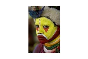 Face Painting of a Huli Man from Papua New Guinea - This is photo of a Huli Tribesman from the highlands of Papua New Guinea. He paints his face and has human hair wig on his head for a traditional dance.