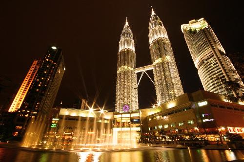 Night View Of Twin Tower At Malaysia - The Petronas Twin Towers were the tallest buildings in the world until Taipei 101 was completed in 2004, as measured to the top of their structural components(spires, but not antennas). Spires are considered integral parts change the appearance and design of the building, whereas antennas may be added or removed without such consequences. The petronas Twin Tower remain the tallest twin building in the world.