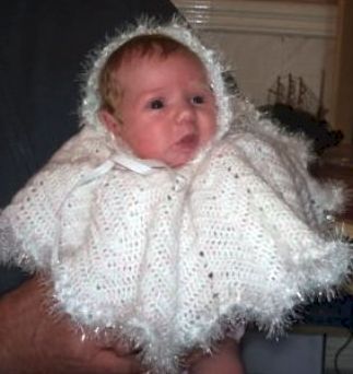 Knitted Poncho - My granddaughter in a knitted poncho I made for her