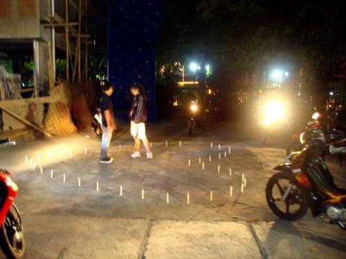 Love confession - It's one of love confession at my school. This confession occured in school's volleyball field. Look, there is candles shaped 'heart' around them. And lamp motorcycle centered them. So romantic