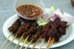 satay - marinated meat bbq'd on skewers served with cucumbers and rice cakes topped with groundnut sauce.