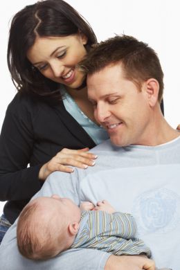 couple with newborn baby - The is a picture of a couple, holding a newborn baby.