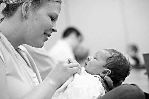 Mother and Son - This is a beautiful black and white picture of a women holding a new born baby.