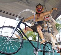 Devils on Bike - Once a year, at the beginning of the Saka year (Balinese calendar), Balinese celebrates “Nyepi” Day or “Silent” Day. “No fire, no sound and no travel”. People living in Bali are not allowed to lit fires, to turn on lights, to make noise or to go out of the house. All ports and airport close for 24 hours. No television relays. Since Bali is a tourist’s destination, special conditions applied to hotels. Hotel operates as normal, however they are to turn off lights on the outside and dim the inside lights. Guests are not allowed to go outside the hotel’s ground and are to have dinner before the sun sets. On the eve of Nyepi Day, there will be “Ogoh-ogoh” parade. This parade symbolizes how Balinese getting rid the devils off the Island. The next day Bali is dark and silent, and hoping all the devils and bad spirits are chased away from the Island. Ogoh-ogoh is made a couple months before the event. Some are really scary, some are funny, and some are imaginary. This is my favorite this year.