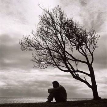 Sad - sad man sittind alone under as tree
