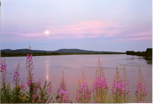 Sun was in North, the Moon in South - The midnight sun was shining right from the North. Looked like a normal sunset. But when I turned to the South, I saw the moon an these wonderful colors.
