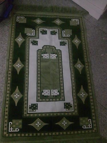 prayer mat, clean praying mat,sajjada - Muslims are obligted to pray to Allah (God) five times a day. 
Muslim can pray anywhere, how ever place are expected a clean place. in that case, Muslims will use a sajjada in the house or out of in the mosque while praying(the Muslim place of worship). 
Sajjada help to substiitute a temporary mosque while praying. 
Prayer mats are decorated in different ways, including geometric patterns, floral patterns and pictures of famous mosques. Prayer mats always have an arch design on them, and this arch is pointed in the direction of Makkah. The mats will never represent in a picture or sculpture of people or animals as this is forbidden in Islam to avoid idolatry. 
