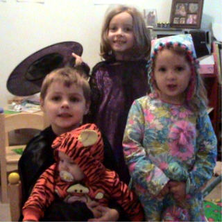 Happy Halloween - Here are my kids dressed up for Halloween (our town went trick or treating last night). from left to right: Owen-5 (as Batman), Nora-6 1/2 months (as Tigger), Meagan-6 (as a witch) and Brenna-almost 4 (as a clown).  I made all but the Tigger costume from scratch.