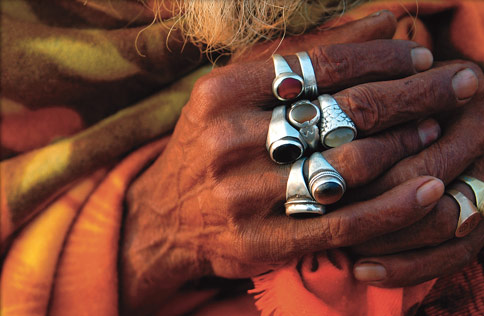 rings in fingers - old man wearing so many rings with fake gemstones