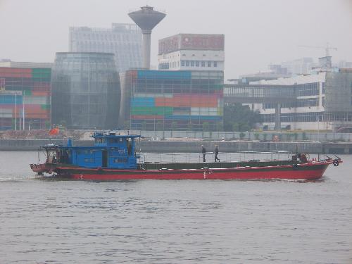 Ship passing colourful buildings on the Pearl Rive - This is a ship passing in front of some colorful buildings.It was taken on the Pearl River on a smoggy day