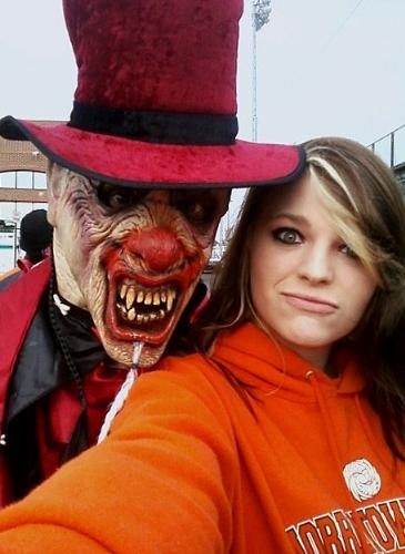 my daughter and her new boss - At her highschool football game she saw the company that she will be working for advertising the haunted attraction and got me a picture of her and her new boss.