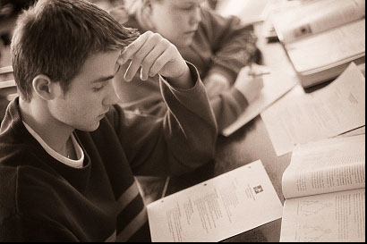 Student  - The picture shows a student who study a lot in order to pass the examination and also for the sake of learning a certain subject matter even to the point of sacrificing his other wants.