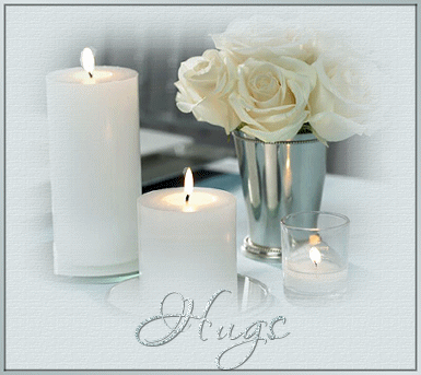 Romantic hugs, - this is a picture with lots of white flowers and candles and it is very romantic looking and it has the word hugs in silver below candles and flowers
