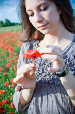 A beautiful young girl holding a flower - Photo was created by "graur razvan ionut". 
Photo was found in http://www.freedigitalphotos.net/images/Younger_Women_g57-Beautiful_Woman_p16535.html