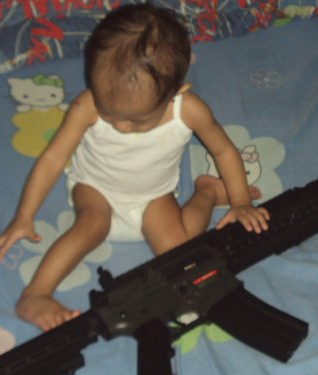 Baby with a BIG GUN - Isn&#039;t this disturbing