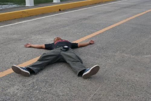 casualty! - After 3 days of trekking. My hubby decided to lie flat on the road while waiting for a bus.
