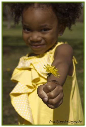 Yazzy - Cute little girl who is holding a flower.
