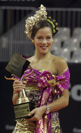 Ana Ivanovic in traditional Balinese outfit with w - Ana holding the winners trophy after her victory in the Bali tournament while dressed in traditional Balinese attire.