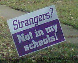 Strangers Not in My Schools - Sign posted on someone&#039;s lawn depicting that strangers are not welcome in schools and that somehow anyone we don&#039;t know must be a danger to all children.