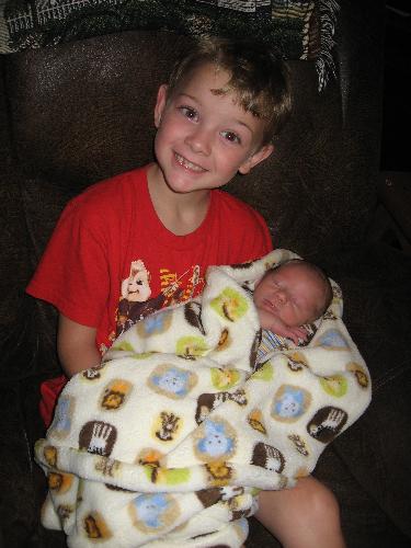 Boy someone is happy to be a big brother - My oldest holding his new little brother.