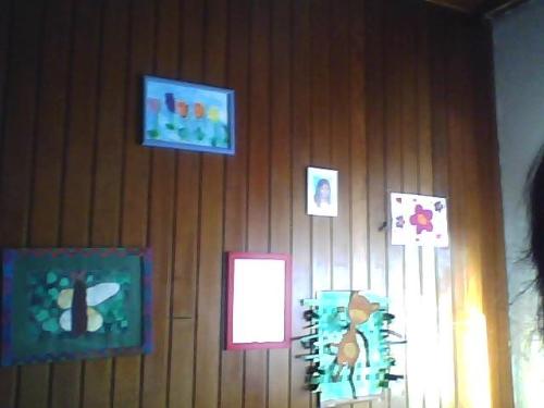 Hang pictures, which your children draw, on the wa - The living room wall is decorated by children's work.