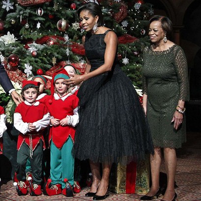 Michelle Obama in Vintage - What’s old is new again for Michelle Obama, who had another groundbreaking moment in fashion history Sunday night, dazzling in one-of-a-kind vintage number by the late designer Norman Norell. The First Lady picked up the black-lace overlay dress, which boasted a full tea-length tulle style skirt and a square neckline (something rarely seen in contemporary designs), at New York Vintage boutique, signaling what store owner Jon Schneck believes to be the first time a first lady has worn a vintage dress to a public event, reports The Huffington Post. Obama donned the elegant 1950s piece to the “Christmas in Washington” concert in Washington, D.C., which airs tonight on TNT and is hosted by Ellen DeGeneres. And while the spectacle, which will feature performances by Mariah Carey, Annie Lennox and more, will surely be packed with flare, we’re sure no one sparkled as brightly as Obama, who glammed up her ballerina-like confection with oversized snowflake drop earrings.