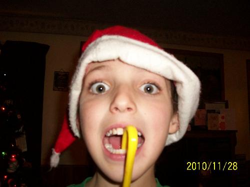 My son with a yellow candy cane. - Christian eating a candy cane!