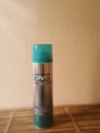 Can of Hairspray  - Can of Rave Hairspray sitting on a wicker shelf.