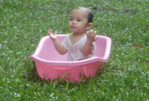 Rain of Blessings! - My niece, 6 months in her stolen moments in the drizzle. I hoped to be child again!