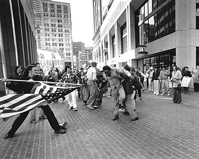 Irony,Hypocrisy or Both - A man is assaulted by another while he participates in a protest to push for education rights.