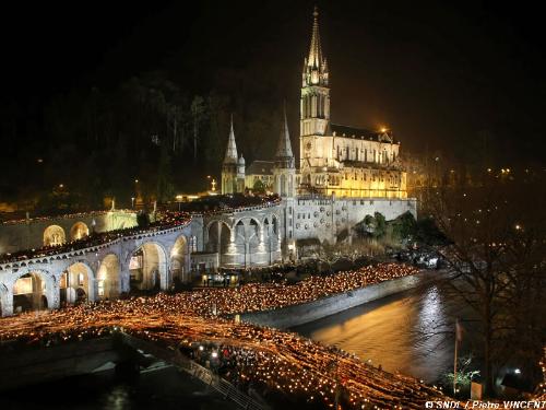 The torchlight procession at lourdes. - Everyone carries torches and forms a procession in the grounds of the basilica. So magical and beautiful. I&#039;ll hold that memory forever.