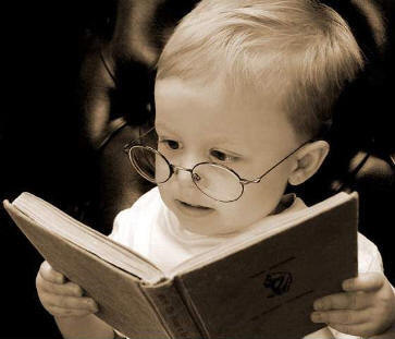 Reading Child - A young child with glasses reading.