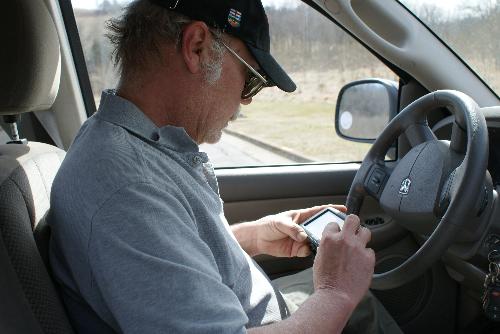 Britt with his new GPS - at the dam Britt setting his GPS for the next destination