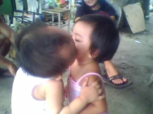 their first kiss  - my nephew kissing his playmate in 2009