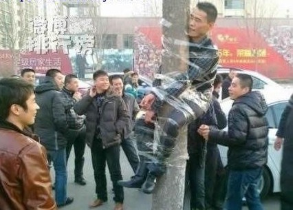 the most funny punishment - See,a thief was glued up to a wire pole!