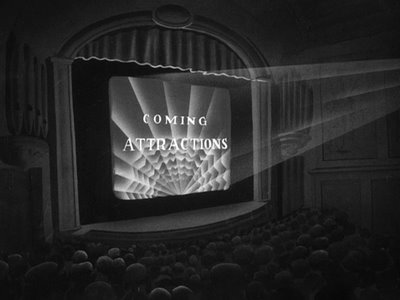 Movie Theater - Black and white photo showing the inside of a movie theater with 'Coming attractions' on the screen.