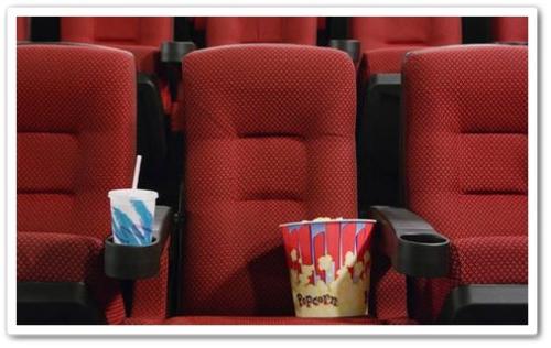 Movie Theater  - A picture of a seat with a drink and popcorn.