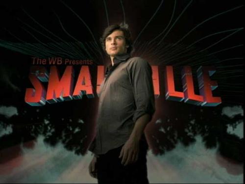 Smallville Poster - Clark Kent (Tom Welling) standing in front of the title Smallville.
