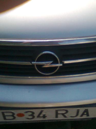 Opel Emblem - Here is the emblem of the Opel Brand on a car in my hood.