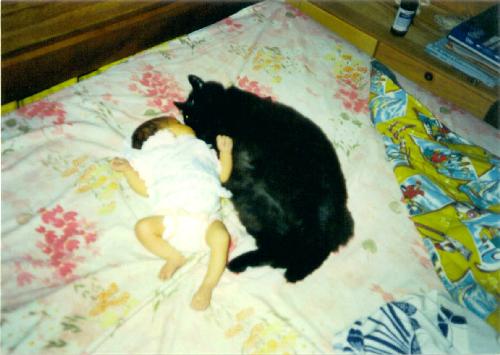 Toby with my Baby - Some babies such their thumbs...My daughter sucked on my cat!