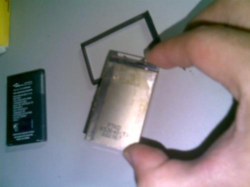 cell phone battery - a picture of my hand dismantling a cell phone battery